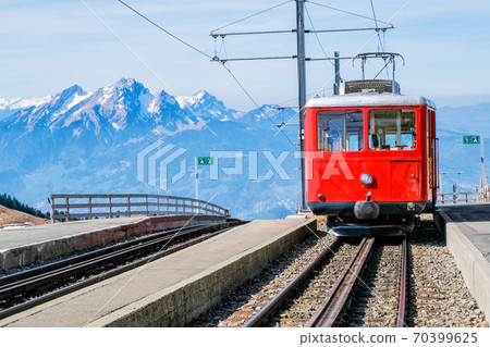 Famous electric red tourist swiss train on Rigi mountain,Switzerland,Europe Famous electric red tourist swiss train on Rigi mountain,Switzerland,Europe 70399625
