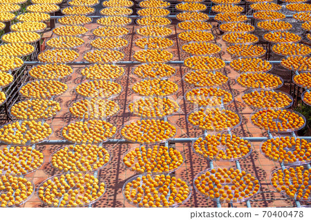 Areal view of the sun persimmons, the traditional way to dry fruit in Taiwan. Areal view of the sun persimmons, the traditional way to dry fruit in Taiwan. 70400478