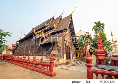 Chiang Mai - Mar 16, 2019: Wat Phan Tao is a beautiful wooden temple sitting next to the famous Wat Chedi Luang Temple. Chiang Mai - Mar 16, 2019: Wat Phan Tao is a beautiful wooden temple sitting next to the famous Wat Chedi Luang Temple. 70400480