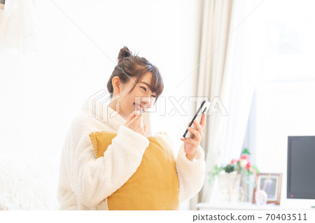 Woman holding a smartphone Woman holding a smartphone 70403511