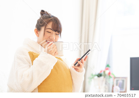 Woman holding a smartphone Woman holding a smartphone 70403517