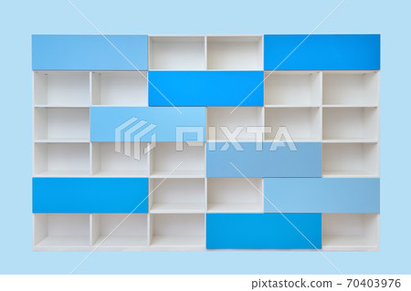 Modern white bookcase with blue doors isolated against blue background 70403976