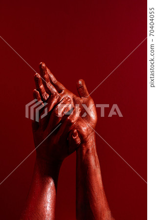 Crop hands smearing red paint against vibrant background Crop hands smearing red paint against vibrant background 70404055
