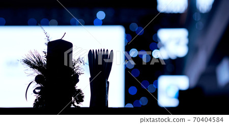 contour of a large candle and a full stand for napkins against the background of the white screen and side contour of a large candle and a full stand for napkins against the background of the white screen and side 70404584