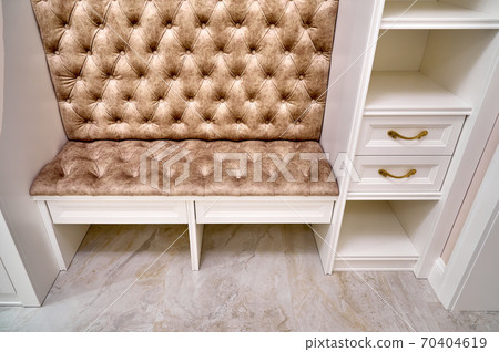 Classic white wardrobe with seating and shelves in contemporary bright hallway. Carriage coupler closet bench 70404619