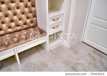 Classic white wardrobe with seating and shelves in contemporary bright hallway. Carriage coupler closet bench Classic white wardrobe with seating and shelves in contemporary bright hallway. Carriage coupler closet bench 70404620
