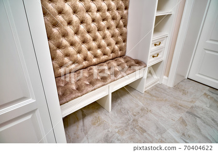 Classic white wardrobe with seating and shelves in contemporary bright hallway. Carriage coupler closet bench 70404622