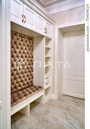 Classic white wardrobe with seating and shelves in contemporary bright hallway. Carriage coupler closet bench Classic white wardrobe with seating and shelves in contemporary bright hallway. Carriage coupler closet bench 70404624