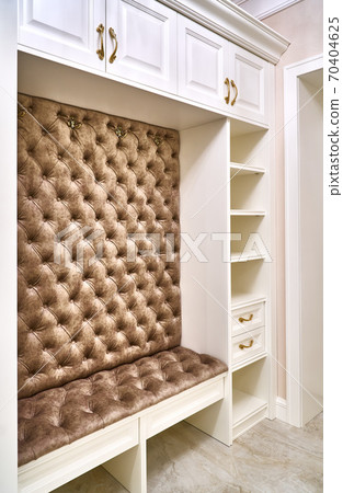 Classic white wardrobe with seating and shelves in contemporary bright hallway. Carriage coupler closet bench Classic white wardrobe with seating and shelves in contemporary bright hallway. Carriage coupler closet bench 70404625