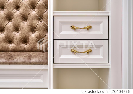 Classic white wardrobe with seating and shelves in contemporary bright hallway. Carriage coupler closet bench Classic white wardrobe with seating and shelves in contemporary bright hallway. Carriage coupler closet bench 70404736