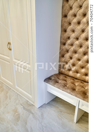 Classic white wardrobe with seating in contemporary bright hallway. Carriage coupler closet bench Classic white wardrobe with seating in contemporary bright hallway. Carriage coupler closet bench 70404772