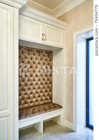 Classic white wardrobe with seating in contemporary bright hallway. Carriage coupler closet bench 70404776
