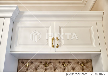 Classic white wardrobe with seating in contemporary bright hallway. Carriage coupler closet bench Classic white wardrobe with seating in contemporary bright hallway. Carriage coupler closet bench 70404877
