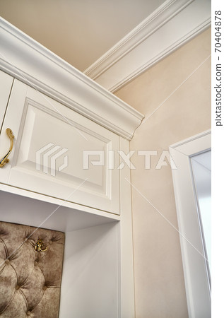 Classic white wardrobe with seating in contemporary bright hallway. Carriage coupler closet bench Classic white wardrobe with seating in contemporary bright hallway. Carriage coupler closet bench 70404878