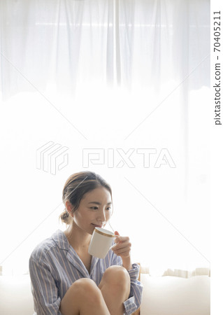 A woman relaxing at tea time A woman relaxing at tea time 70405211