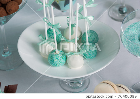 on a plate many multi-colored pop cake on a festive table, wedding candy bar on a plate many multi-colored pop cake on a festive table, wedding candy bar 70406089