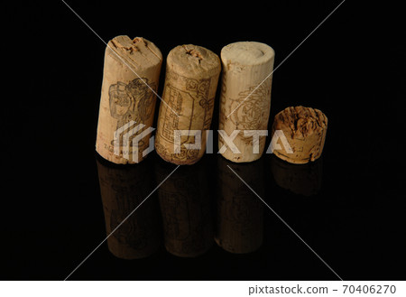 Heap of old wine corks on black background with reflection. Studio photography 70406270