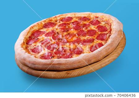 Italian pizza floating in the air with cheese and salami, on pastel blue background, food Italian pizza floating in the air with cheese and salami, on pastel blue background, food 70406436