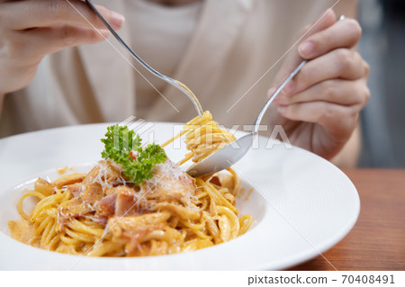 Close-up on Woman Eating Spaghetti with a Fork Close-up on Woman Eating Spaghetti with a Fork 70408491