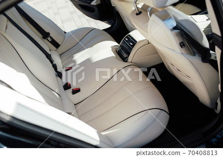 The back seat of a premium car. Beige leather and control system The back seat of a premium car. Beige leather and control system 70408813
