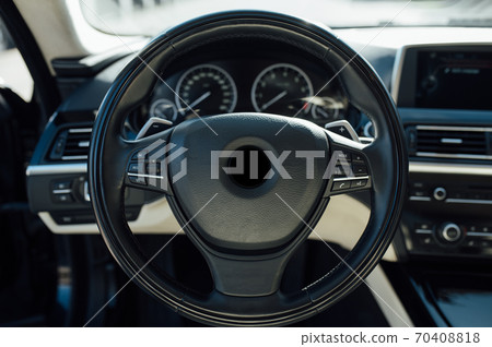 Car inside driver place. Interior of prestige modern car. Front seats with steering wheel Car inside driver place. Interior of prestige modern car. Front seats with steering wheel 70408818