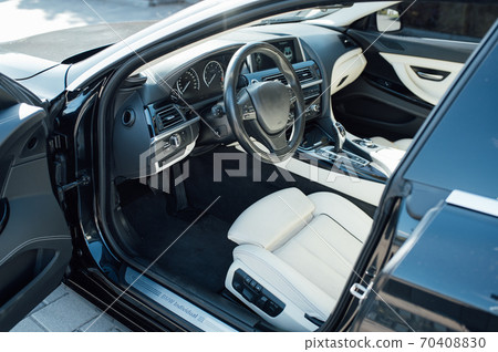 Car inside driver place. Interior of prestige modern car. Front seats with steering wheel Car inside driver place. Interior of prestige modern car. Front seats with steering wheel 70408830