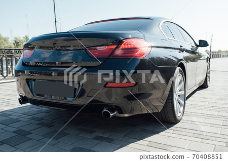 The rear of a luxury car in black The rear of a luxury car in black 70408851