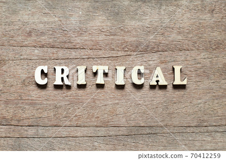 Alphabet letter block in word critical on wood background 70412259