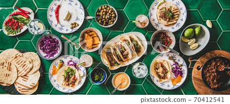 Home taco party with tortillas and tomato salsa 70412541