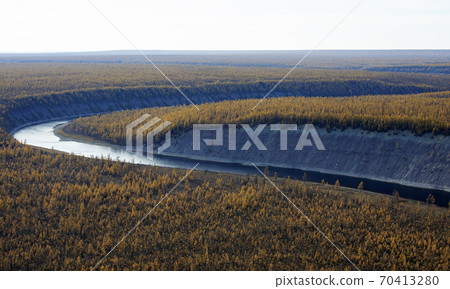 Helicopter view of the turn of the Siberian river flowing among the autumn larch taiga Helicopter view of the turn of the Siberian river flowing among the autumn larch taiga 70413280
