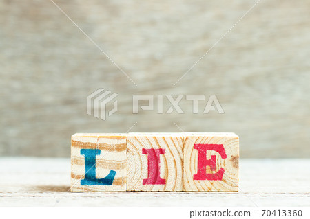 Alphabet letter in word lie on wood background Alphabet letter in word lie on wood background 70413360
