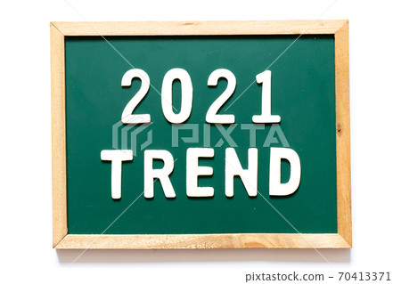Green blackboard and wood frame with word 2021 trend on white background 70413371