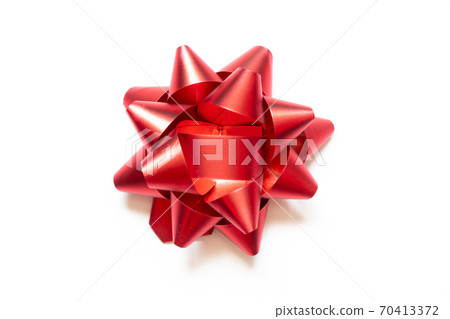 Ribbon bow banner in red color on white paper background 70413372