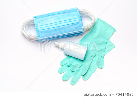 Disposable blue medical face mask, rubber latex gloves and alcohol hand sanitizer antiseptic on light grey background 70414085