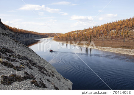 Landscape with a boat on the surface of the river at sunset in autumn. 70414098