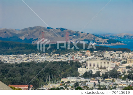 A distant view of the Golden Gate Bridge over San Francisco Bay from the Twin Peaks Observatory A distant view of the Golden Gate Bridge over San Francisco Bay from the Twin Peaks Observatory 70415619