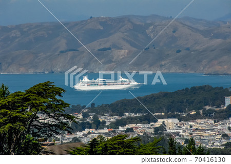 A distant view of a luxury liner entering San Francisco Bay from the Twin Peaks Observatory (in front of the Golden Gate Bridge) 70416130