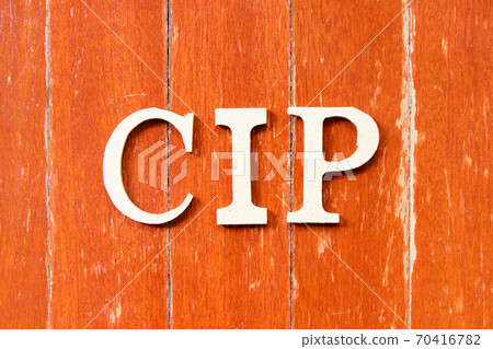 Alphabet letter in word CIP (Abbreviation of Carriage and Insurance Paid To) on old red color wood plate background 70416782