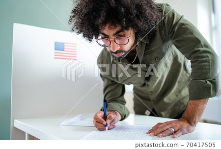 Man voter in polling place, usa elections concept. Man voter in polling place, usa elections concept. 70417505