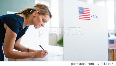Portrait of woman voter in polling place, usa elections concept. 70417507