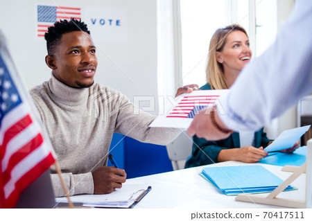 People voting in polling place, usa elections and coronavirus. 70417511