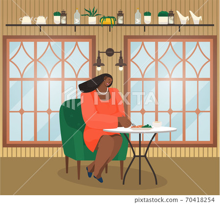 Cafe interior or restaurant, young african woman sitting at table eating, have lunch or dinner 70418254