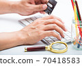 Person entering number of credit card with white 70418583