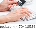 Person entering number of credit card with white 70418584
