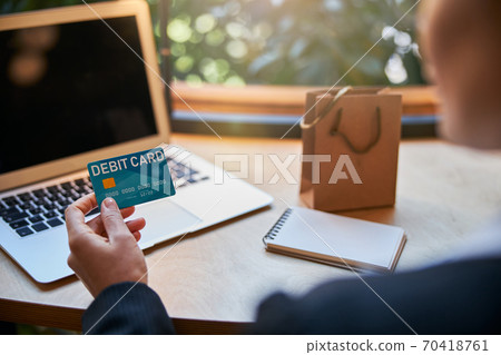 Focused photo on female hand which holding debit card 70418761