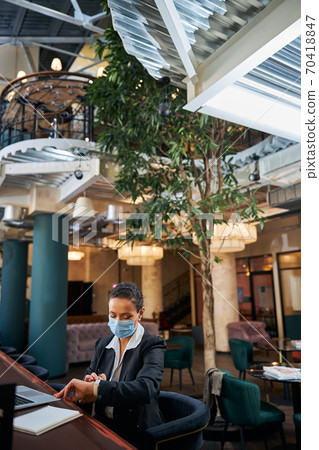 Attentive female person working on the distance 70418847