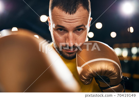 Determined sportsman hitting someone with a well-placed strike 70419149