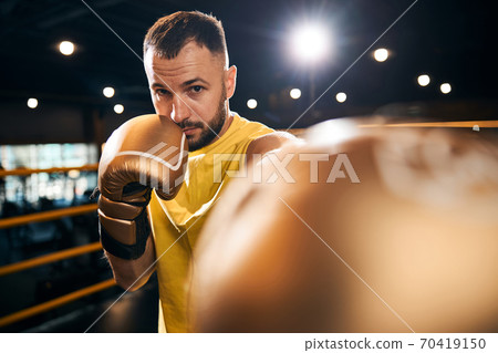 Collected fighter attacking his opponent with a punch 70419150