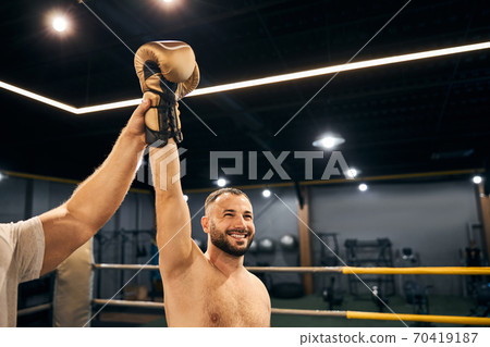 Happy male champion is enjoying his victory Happy male champion is enjoying his victory 70419187