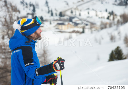 Skier in goggles look at mountains Skier in goggles look at mountains 70422103